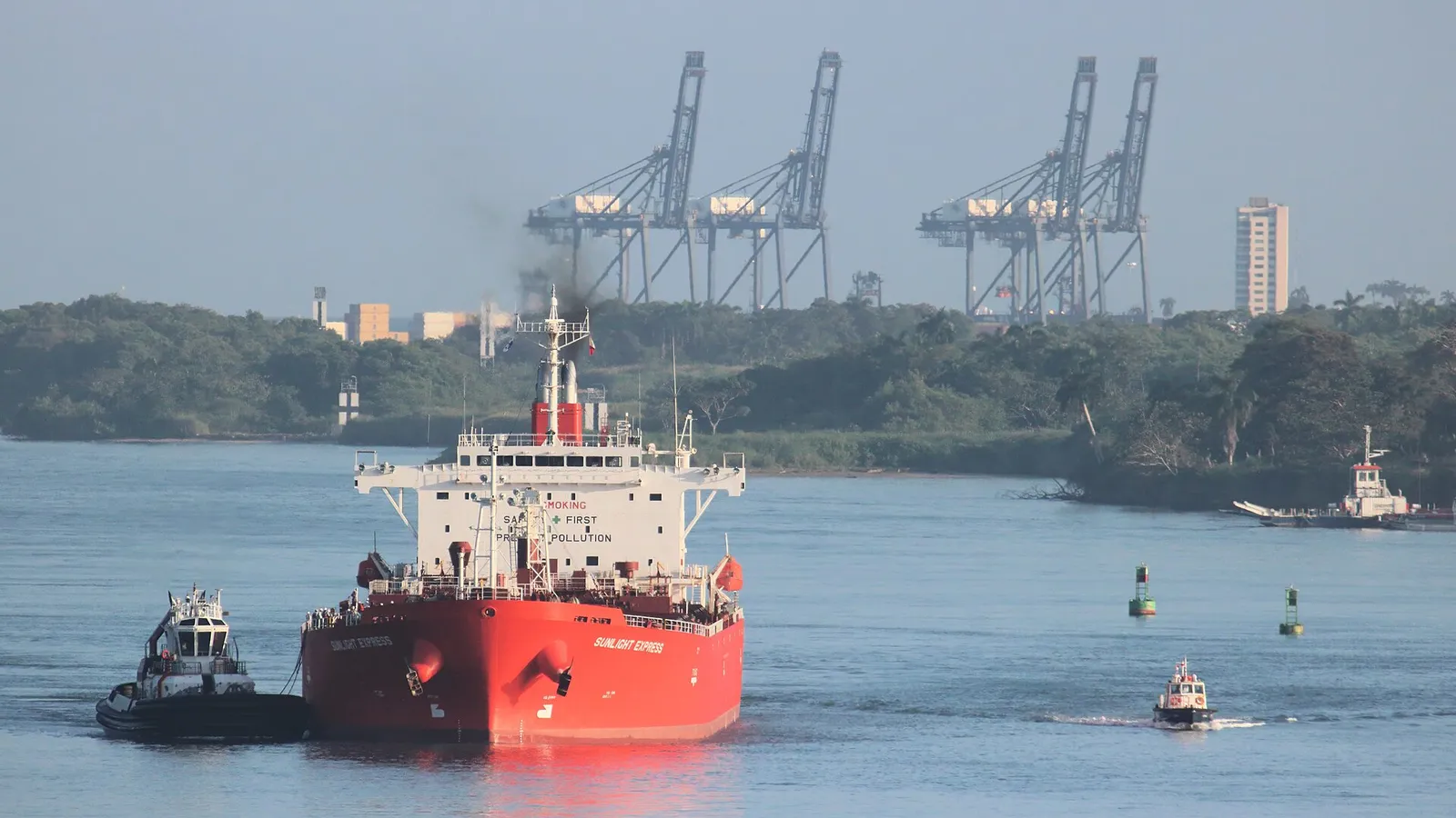 An oil tanker and a tug approaching the Gatun Locks